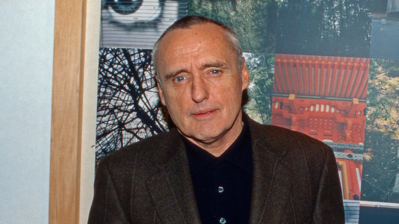 Dennis Hopper in front of framed photos