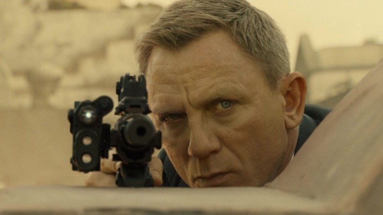 James Bond peering over rifle (2015)