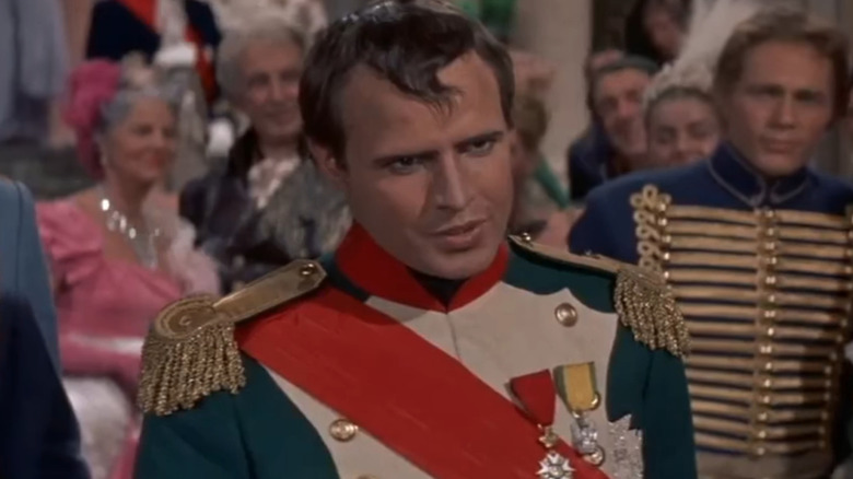 Napoleon standing in crowded ballroom (1954)