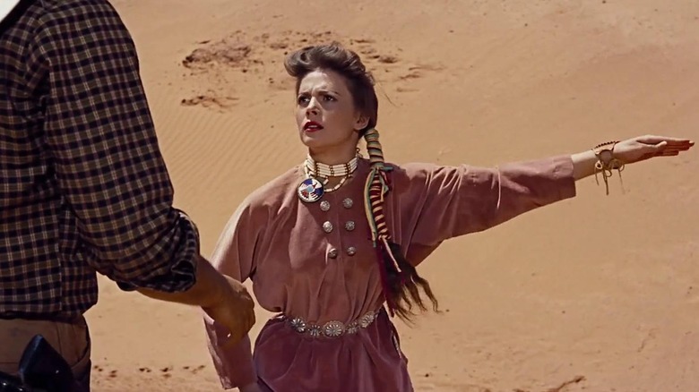 Debbie holds out her arm in desert