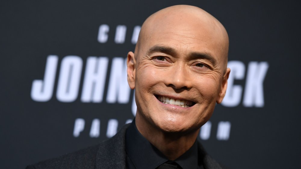 Mark Dacascos smiles in a black shirt at a screening of John Wick: Chapter 3 - Parabellum