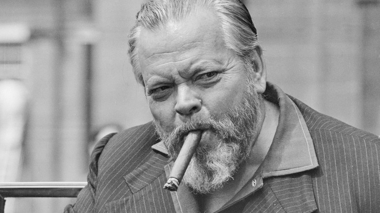 Orson Welles smokes a cigar