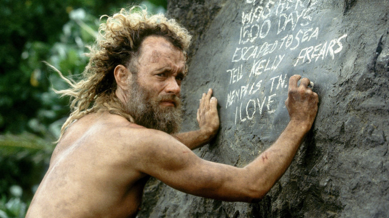 Chuck writing on a rock