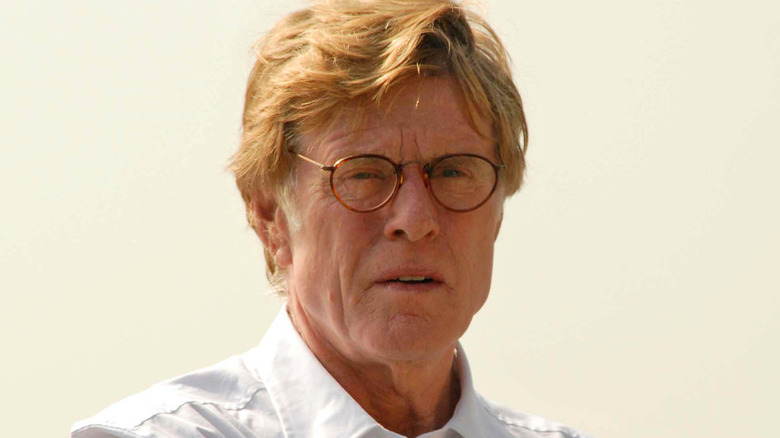 Robert Redford in a white shirt and glasses