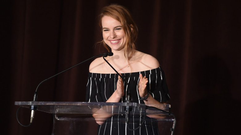 Bridgit Mendler clapping at podium at 4th Annual Save the Children Illumination Gala