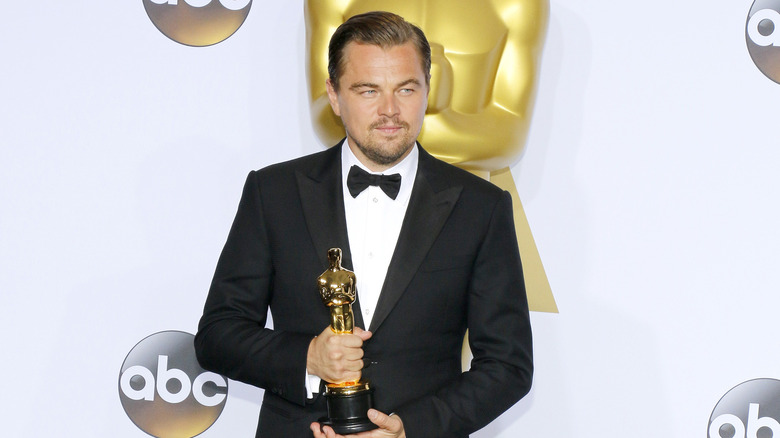 Leonardo DiCaprio holds his Oscar.