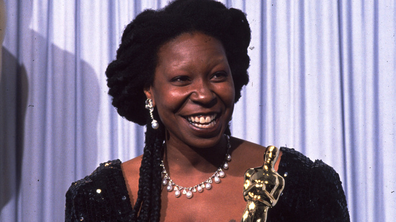 Whoopi Goldberg shows off her Oscar