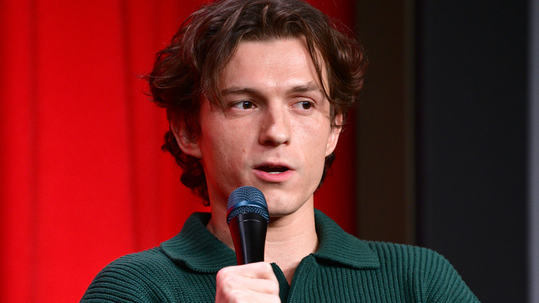 Tom Holland holding microphone