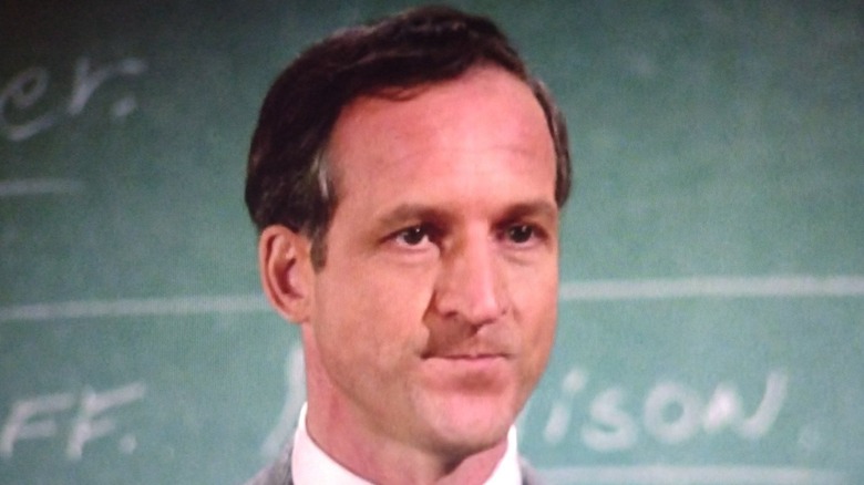 Daniel J. Travanti stands by a chalkboard