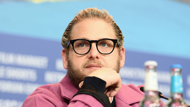 Jonah Hill listening to reporters at a press conference