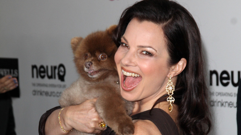 Fran Drescher holds her dog