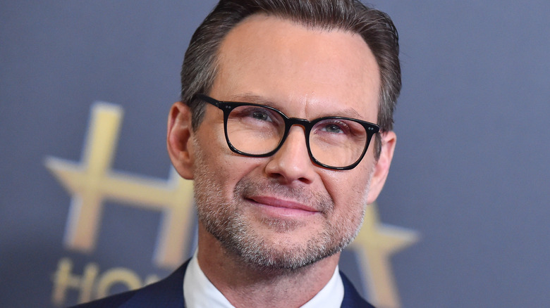 Christian Slater closed smile looks up