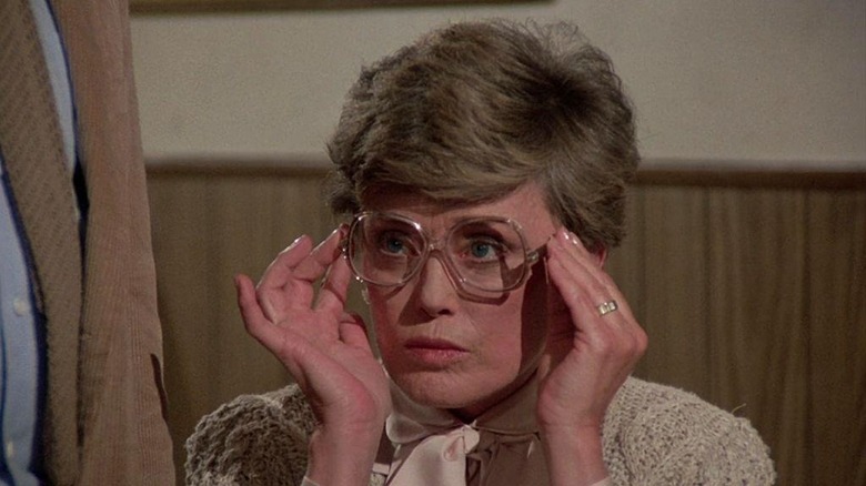 Rue McClanahan adjusting her glasses