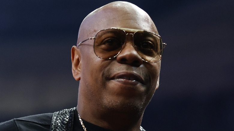 Dave Chappelle wears tinted glasses