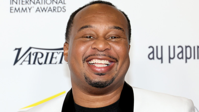 Roy Wood Jr. wears a white jacket