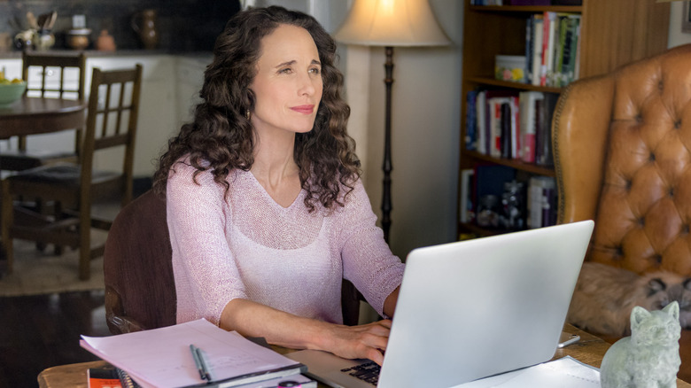 Andie MacDowell works on a laptop