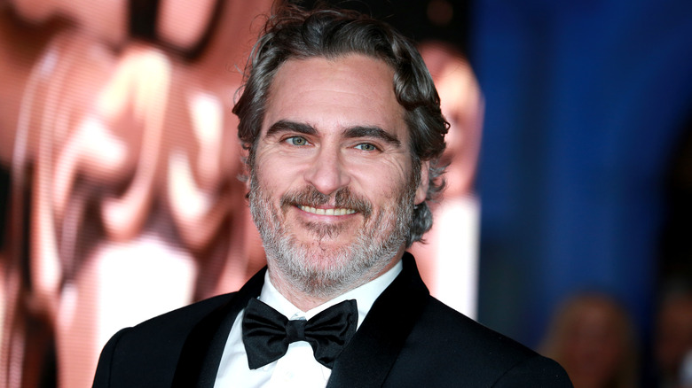 Joaquin Phoenix smiling in tuxedo