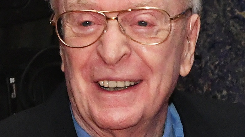 Michael Caine laughing at a gala party in 2021