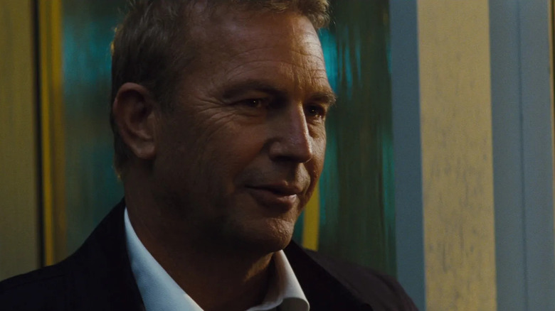 Kevin Costner half-smiles in close-up