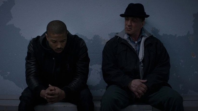 Rocky and Adonis Creed sitting on bench