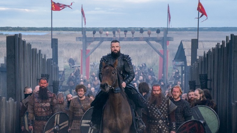 Bradley Freegard on horseback, entering village