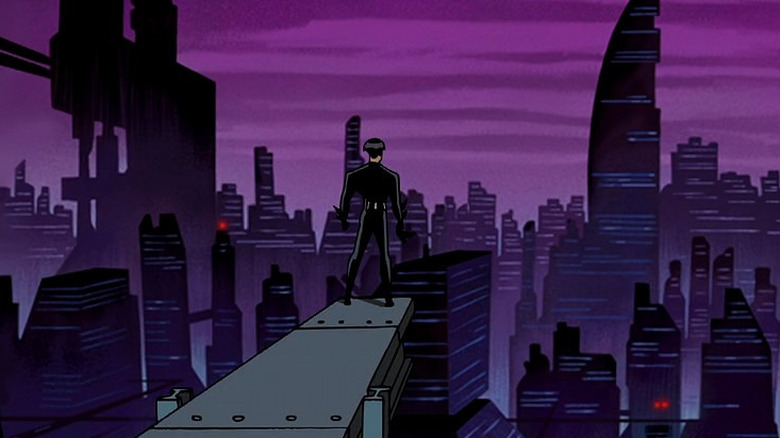 Batman Beyond's Batman standing over Neo-Gotham