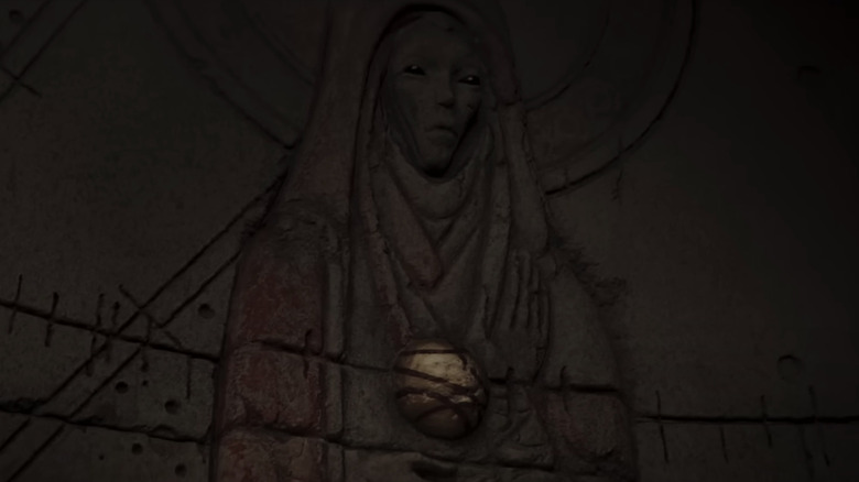 Mysterious stone figure holding golden orb