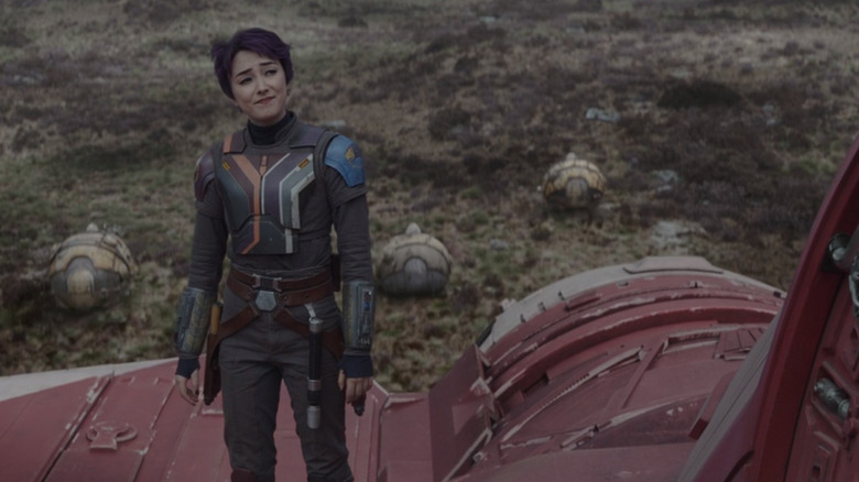 Sabine stands on ship smiling