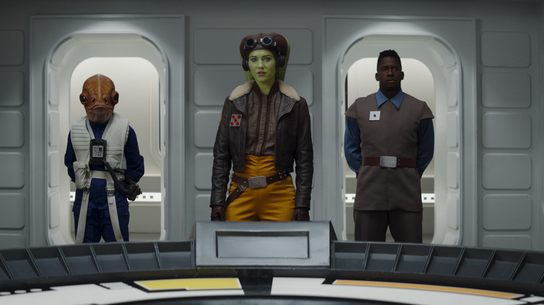 Hera stands between two New Republic officials