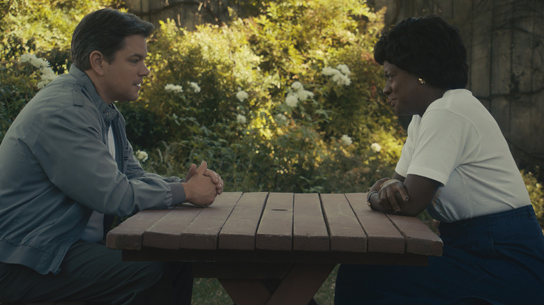 AIR's Sonny Vaccaro looking at Deloris Jordan at picnic table