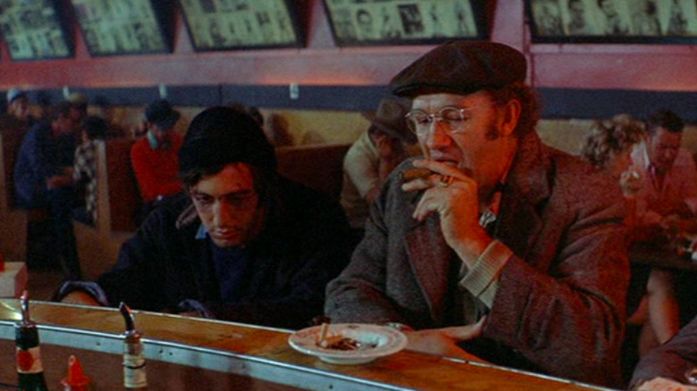 Gene Hackman and Al Pacino, both seated