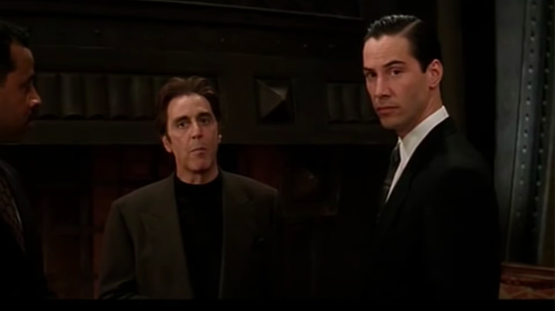 Al Pacino and Keanu Reeves both looking off