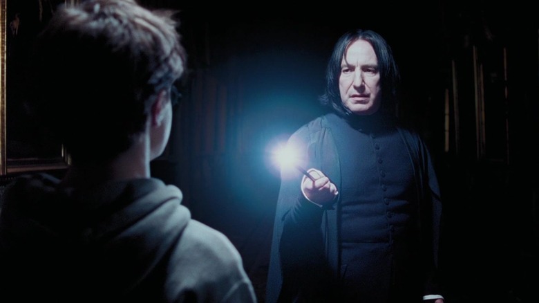 Snape shines his wand on Harry Potter