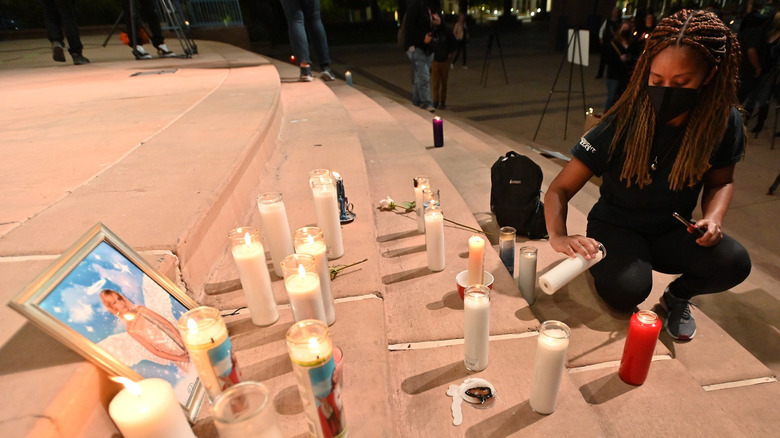 Actor Sarah Wilkinson lights a candle