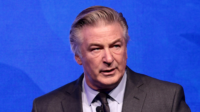 Alec Baldwin suit blue background