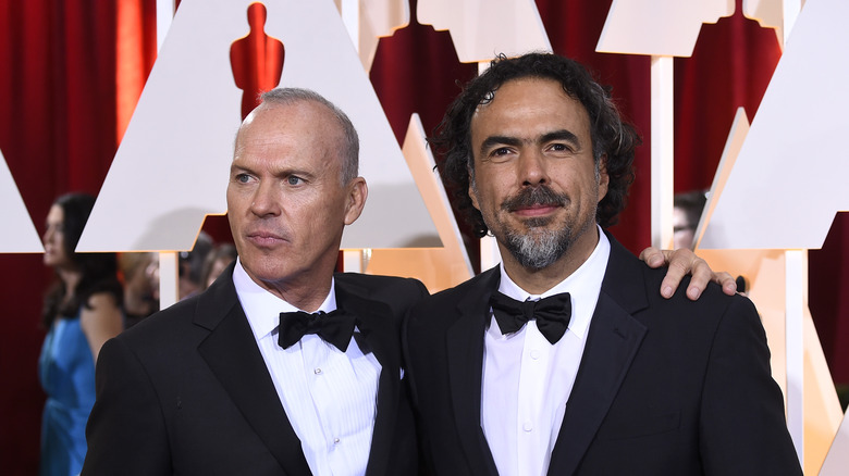 Michael Keaton and Alejandro G. Iñárritu stand together