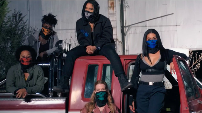 The femme gang of Asking For It posing in masks