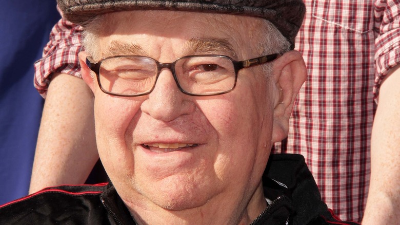 Marvin Kaplan, wearing glasses, smiling