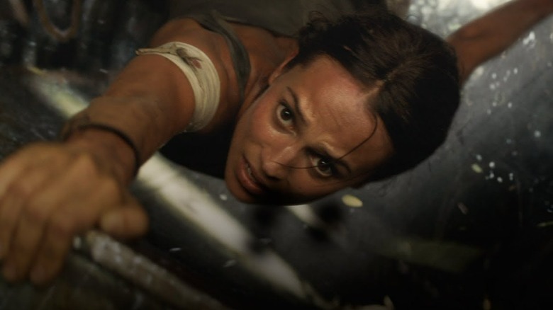 Lara Croft holding onto a ledge