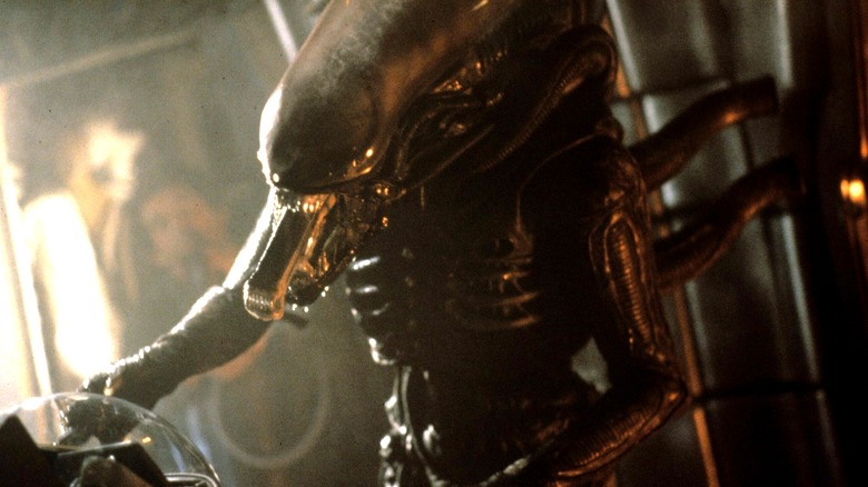 An Alien Xenomorph with its second jaw protruding in Alien (1979)