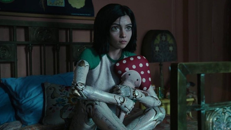 Alita clutches a stuffed animal