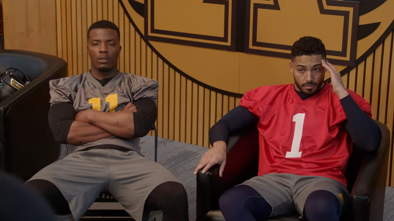 Spencer and Jordan sitting in football jerseys