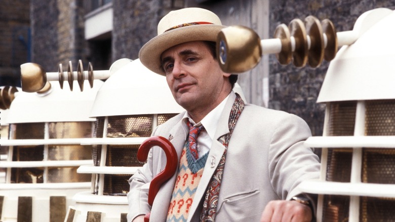 Seventh Doctor posing with Daleks