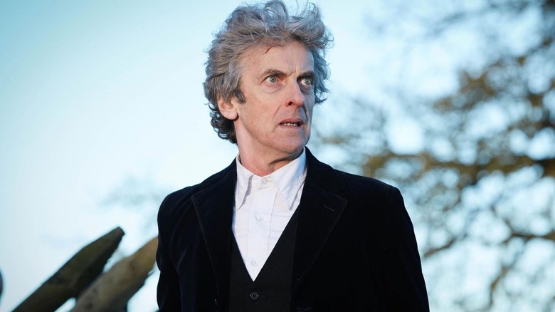 The 12th doctor looking incensed in a wooded area