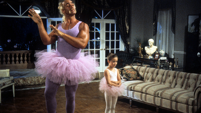 Sean wearing a tutu and dancing while Kate looks incredulous in Mr. Nanny (1993)