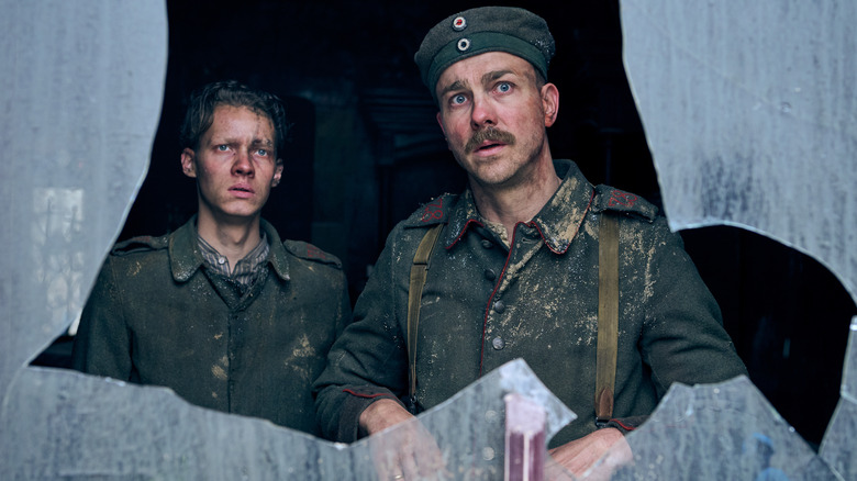 Albrecht Schuch and Felix Kammerer staring out window in All Quiet on the Western Front