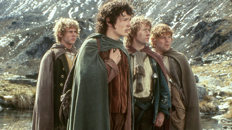 Merry, Frodo, Pippin, and Samwise stand together