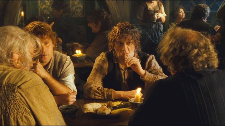Ted Sandyman sits with other hobbits