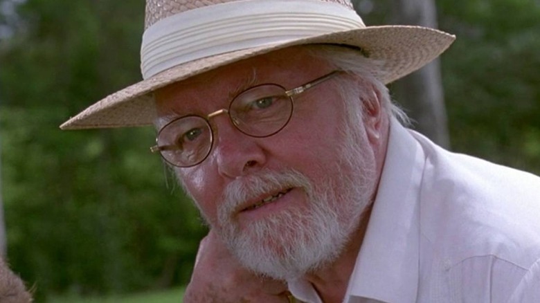 John Hammond observing dinosaurs in the open