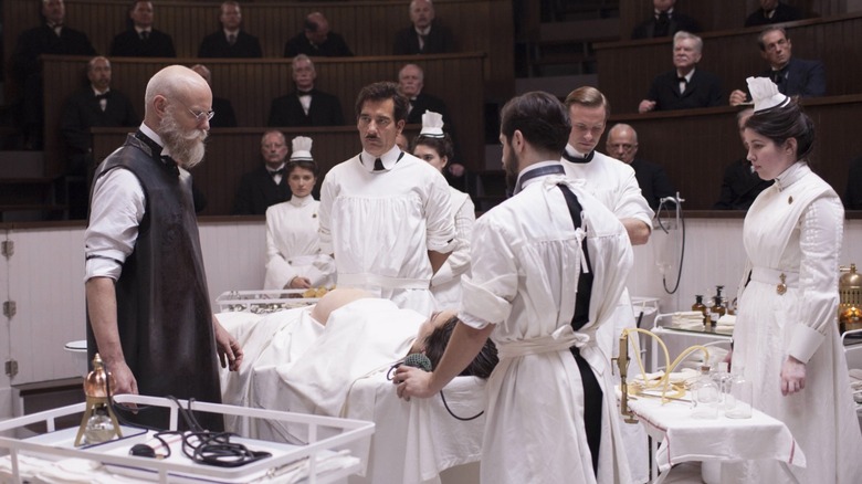 Doctors stand around a patient before surgery